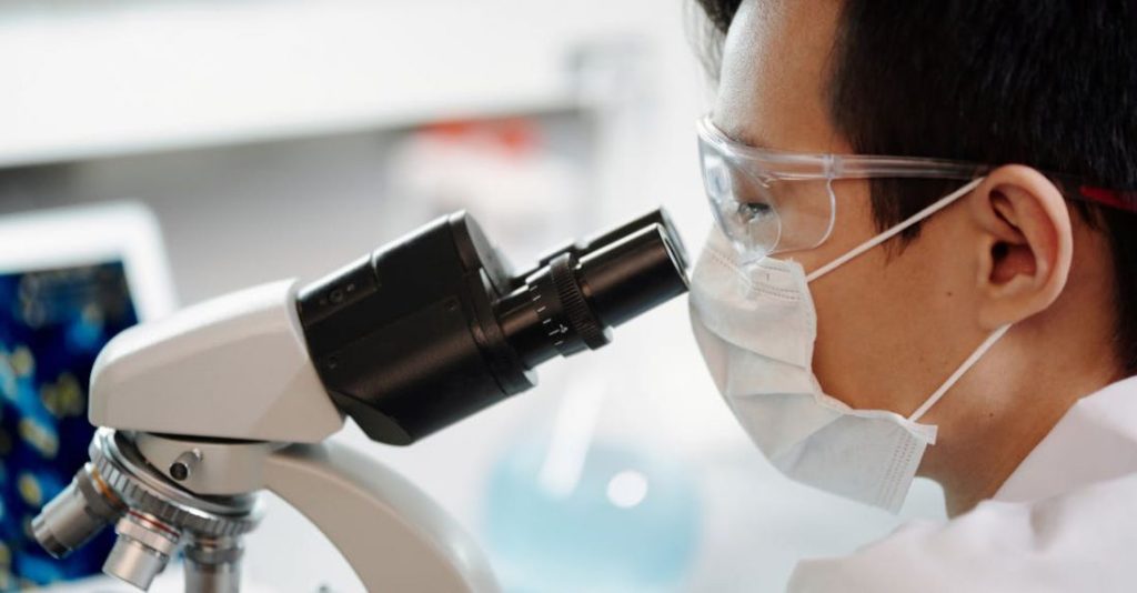 Scientist - Man Looking Through A Microscope