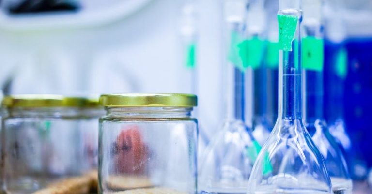 Science - Two Clear Glass Jars Beside Several Flasks