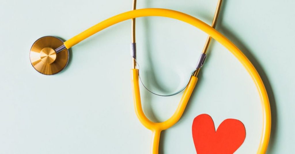 Diagnostics - Medical stethoscope with red paper heart on white surface