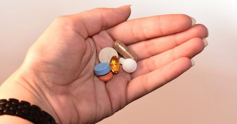 Medicine - Person Holding Medication Pill and Capsules