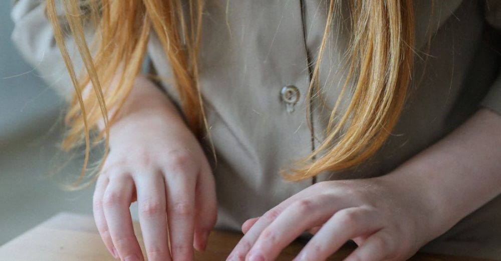 Biology - Crop little girl considering sample of plant